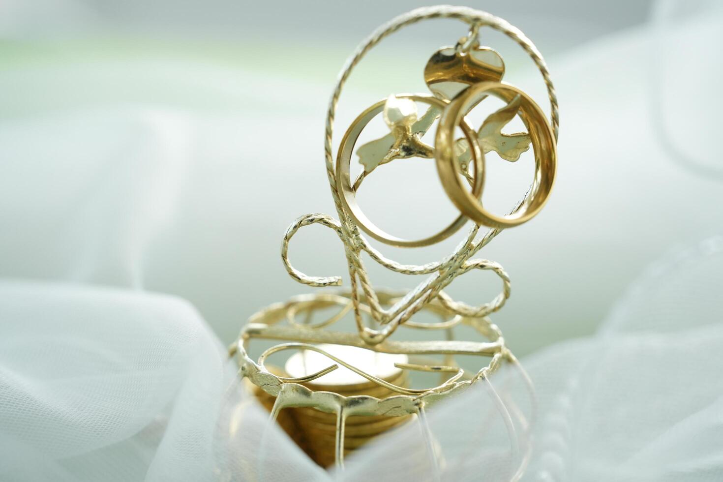 Gold wedding rings on a wedding ring holder photo