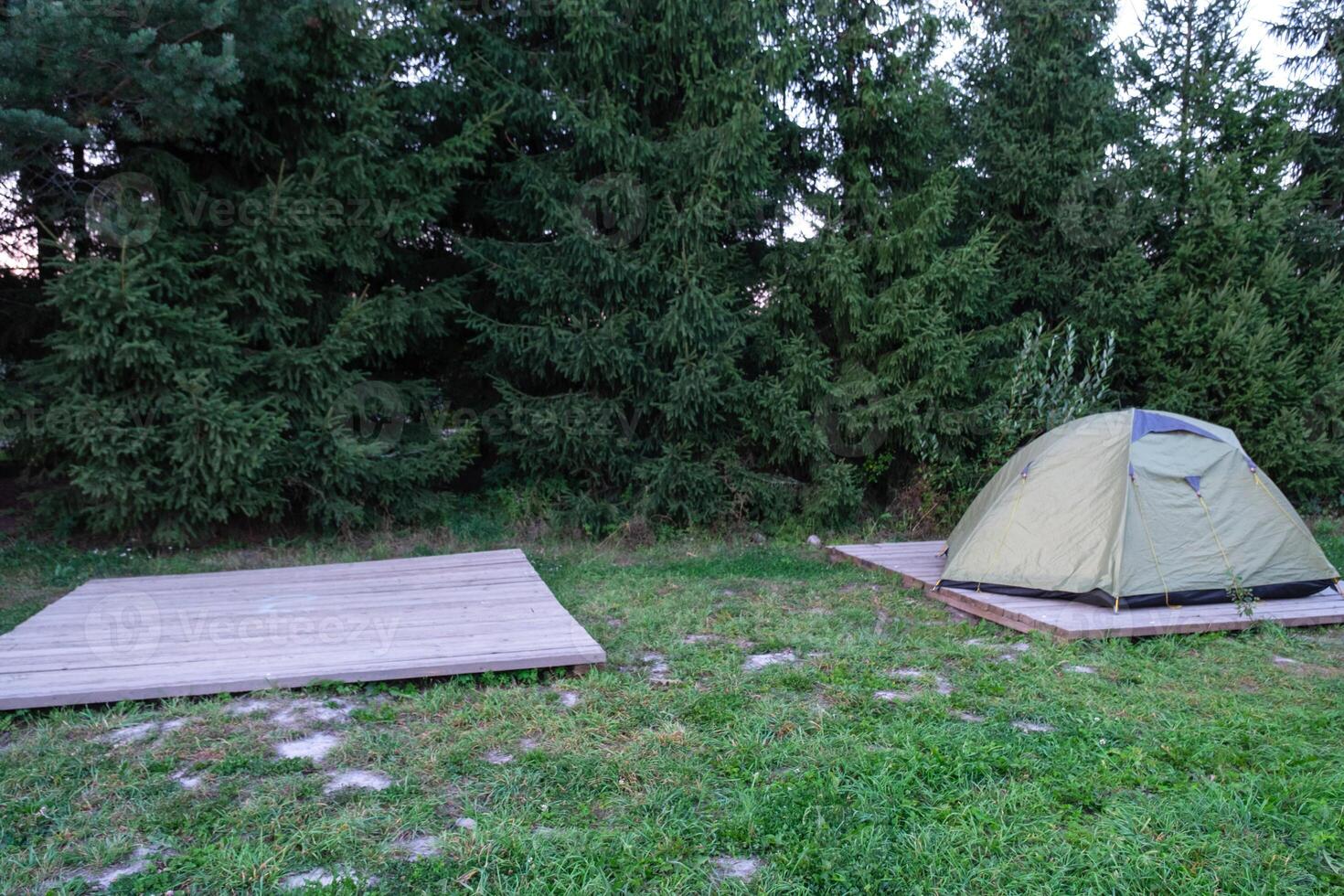 Installed tourist tent in a camping in nature in the forest. Domestic tourism, active summer holidays, family adventures. Ecotourism, sport, hike. Copy space, mock up photo
