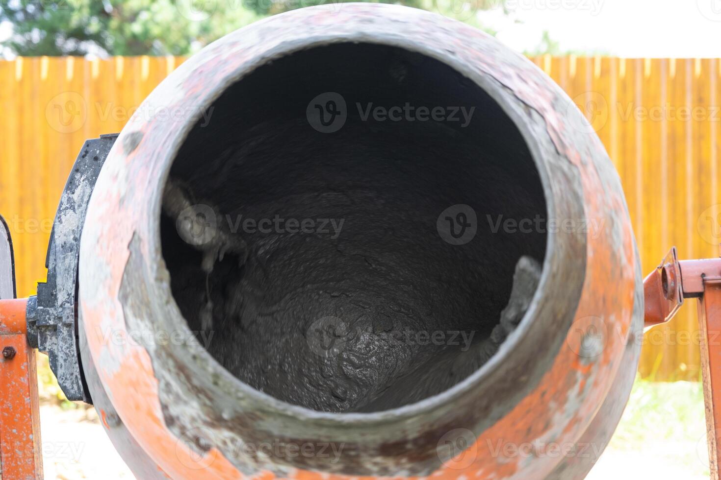 Mixing mortar in a handheld portable concrete mixer photo
