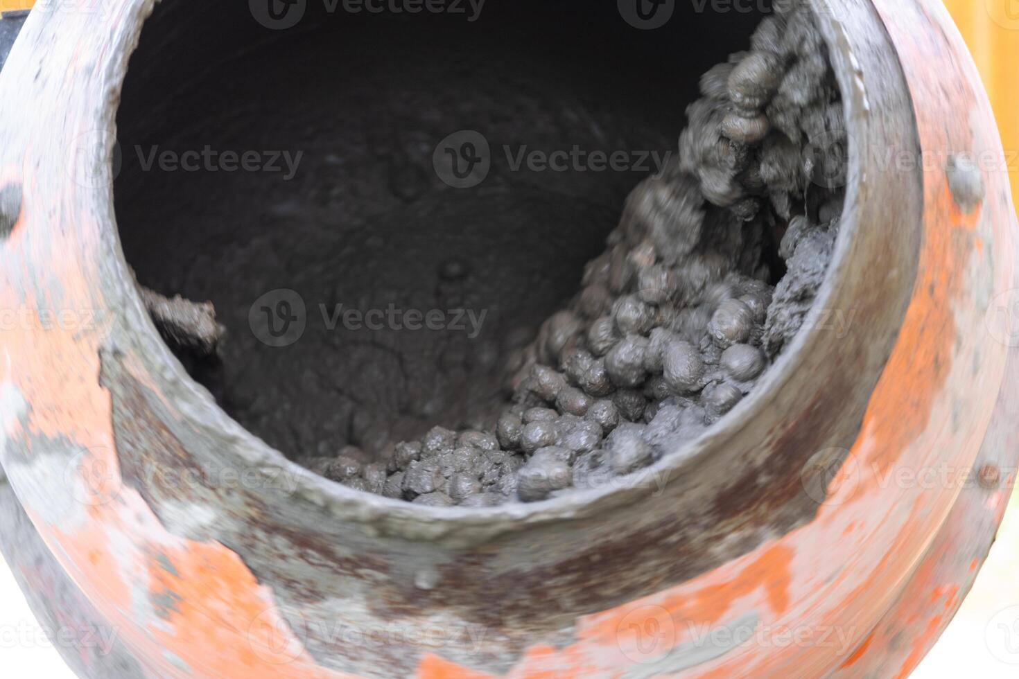Mixing mortar in a handheld portable concrete mixer photo
