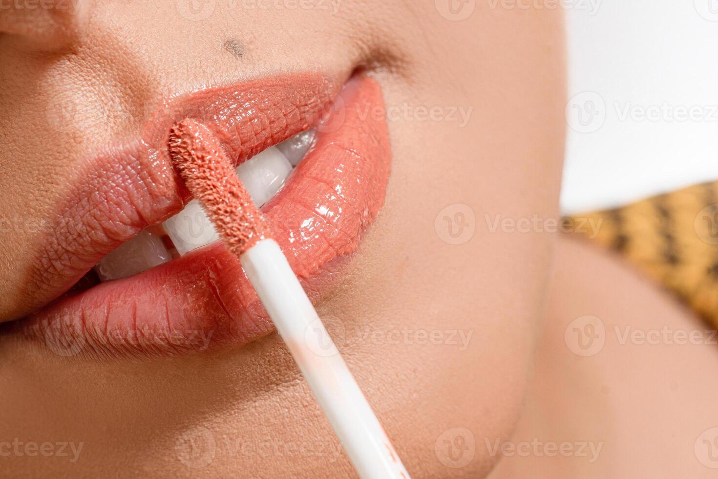 Macro photo, closeup of lipstick with pink color painting a lips. photo