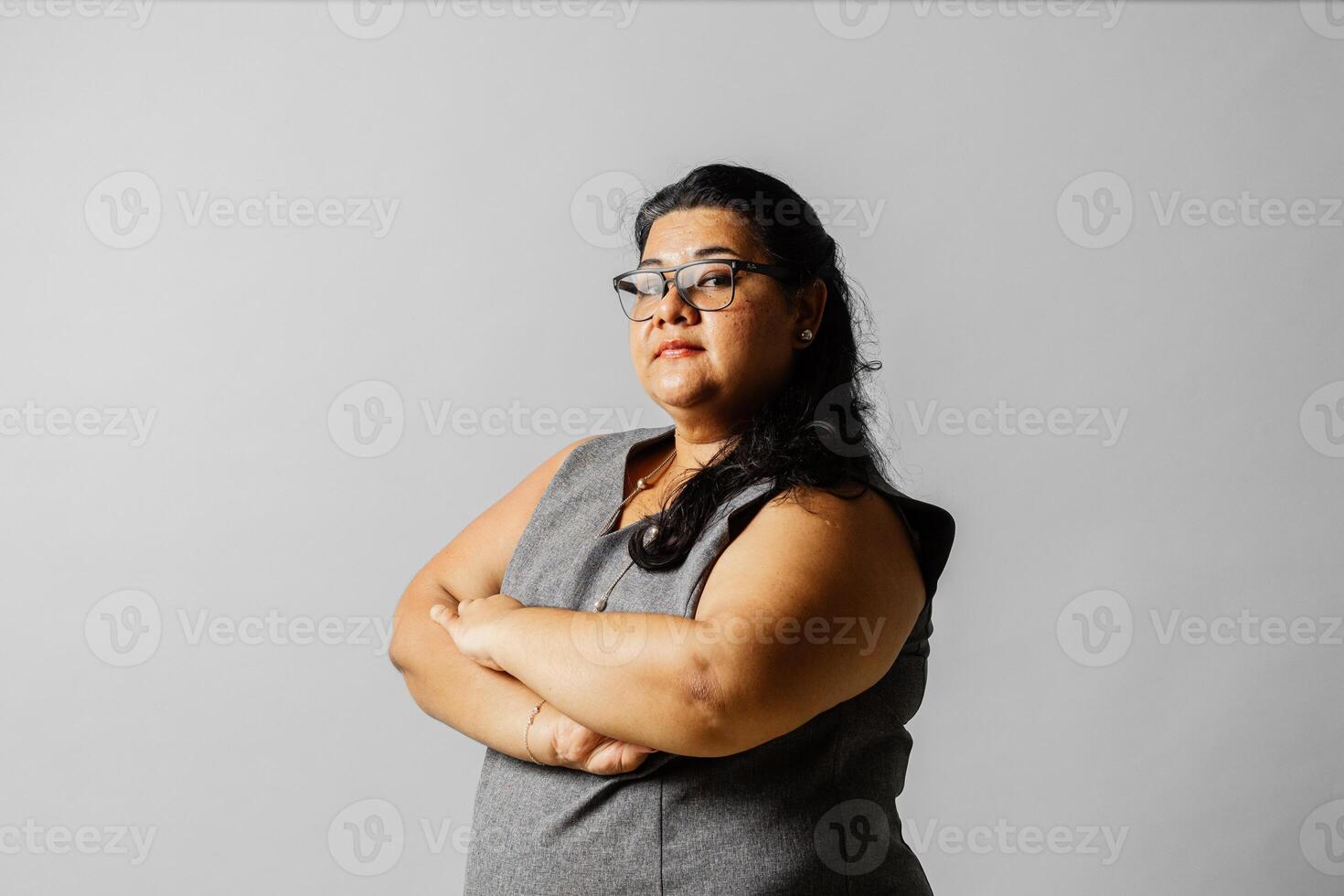 Portrait of a business woman with across arm looking at camera. Feminism concept. photo