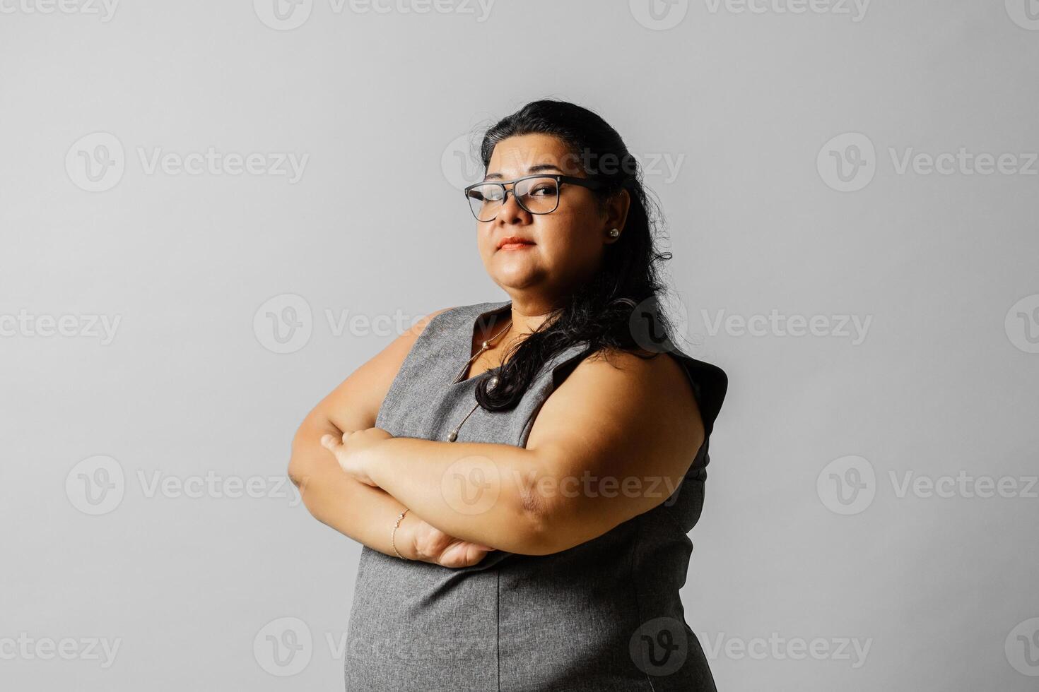 Portrait of a business woman with across arm looking at camera. Feminism concept. photo