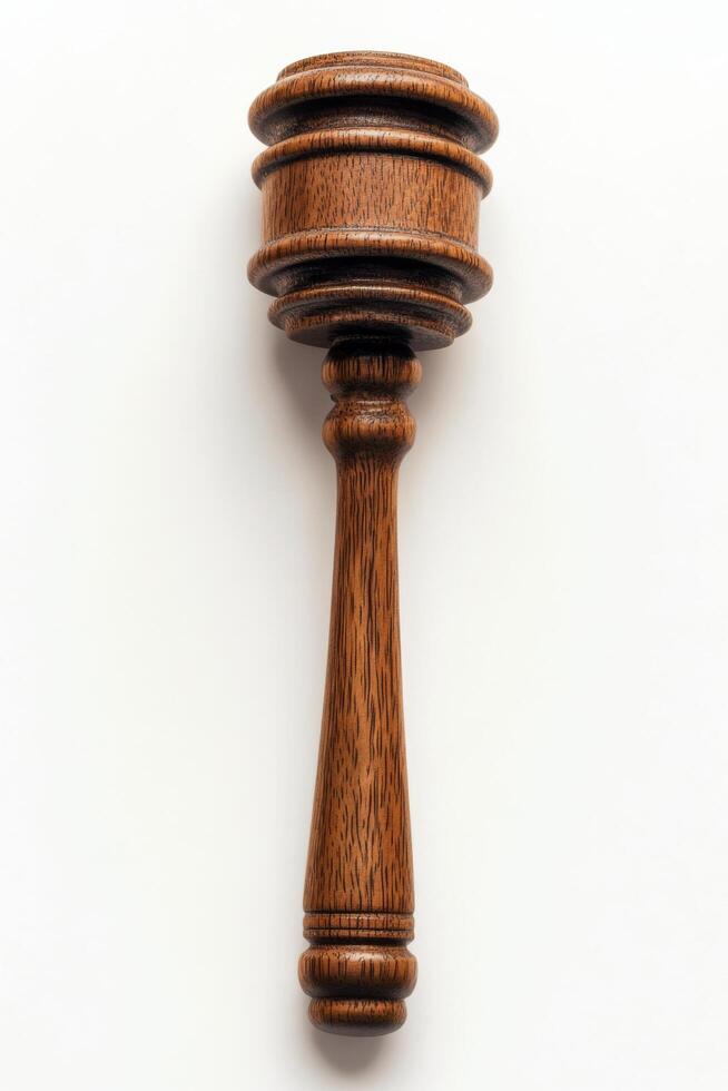 Elegant wooden gavel resting on a smooth white surface suitable for legal proceedings photo