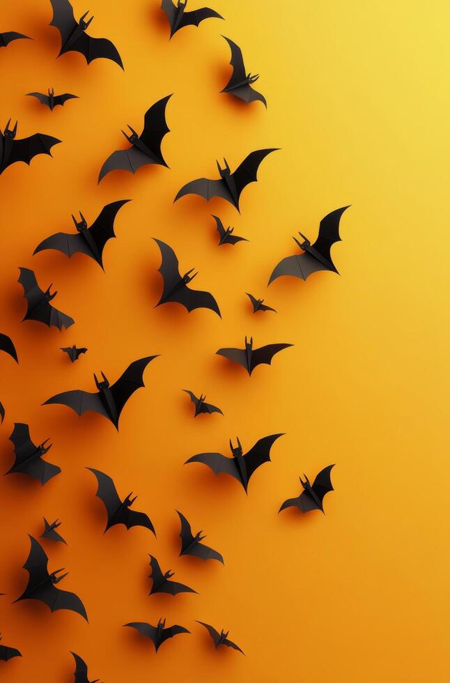 A collection of paper bats flying against a bright orange background during autumn season photo