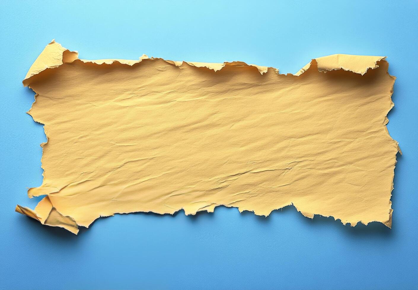 Torn yellow paper against a textured blue background creating a vibrant contrast for design photo