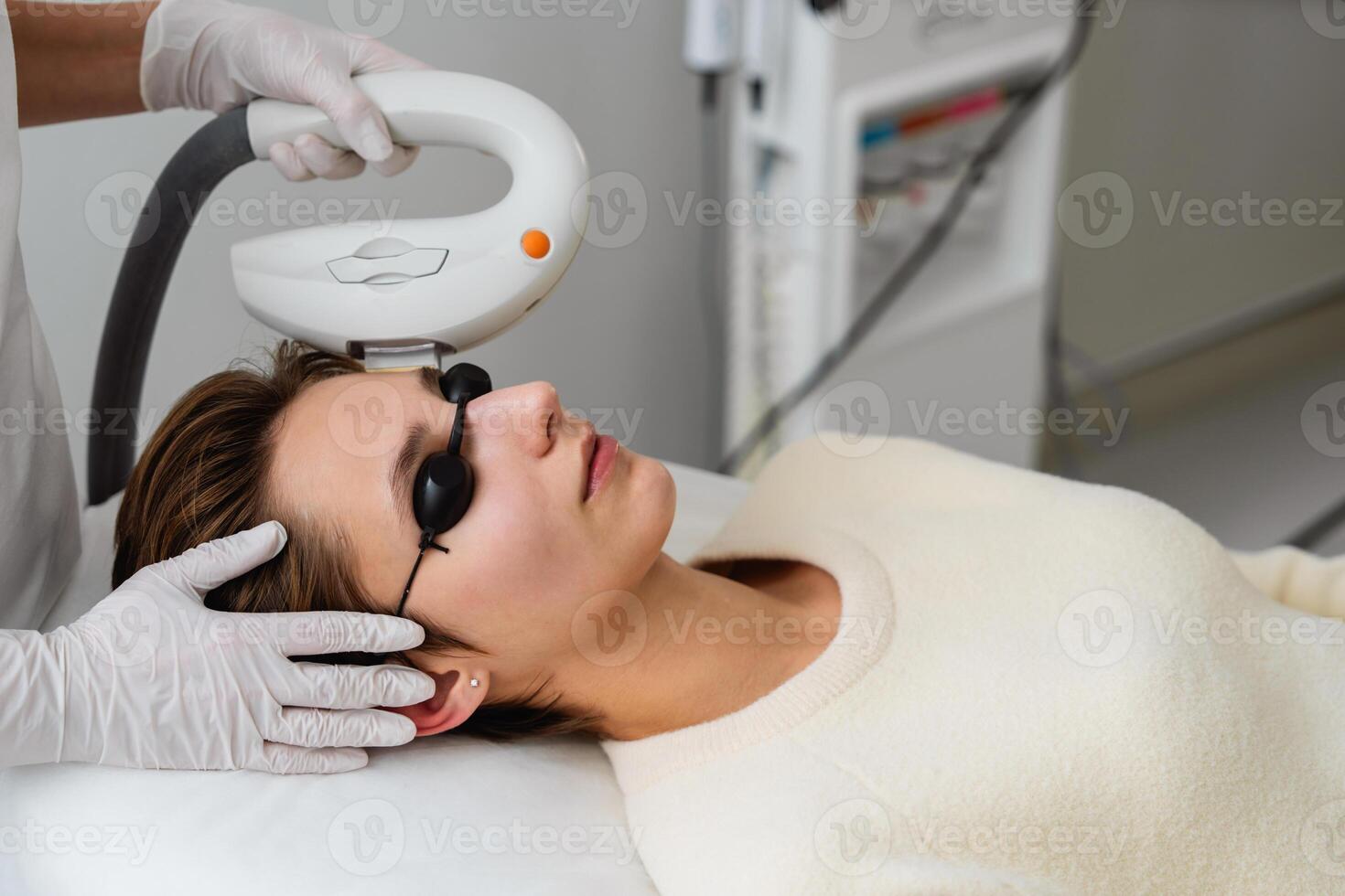Phototherapy, photorejuvenation, IPL in a beauty salon. Care for a woman's face. photo