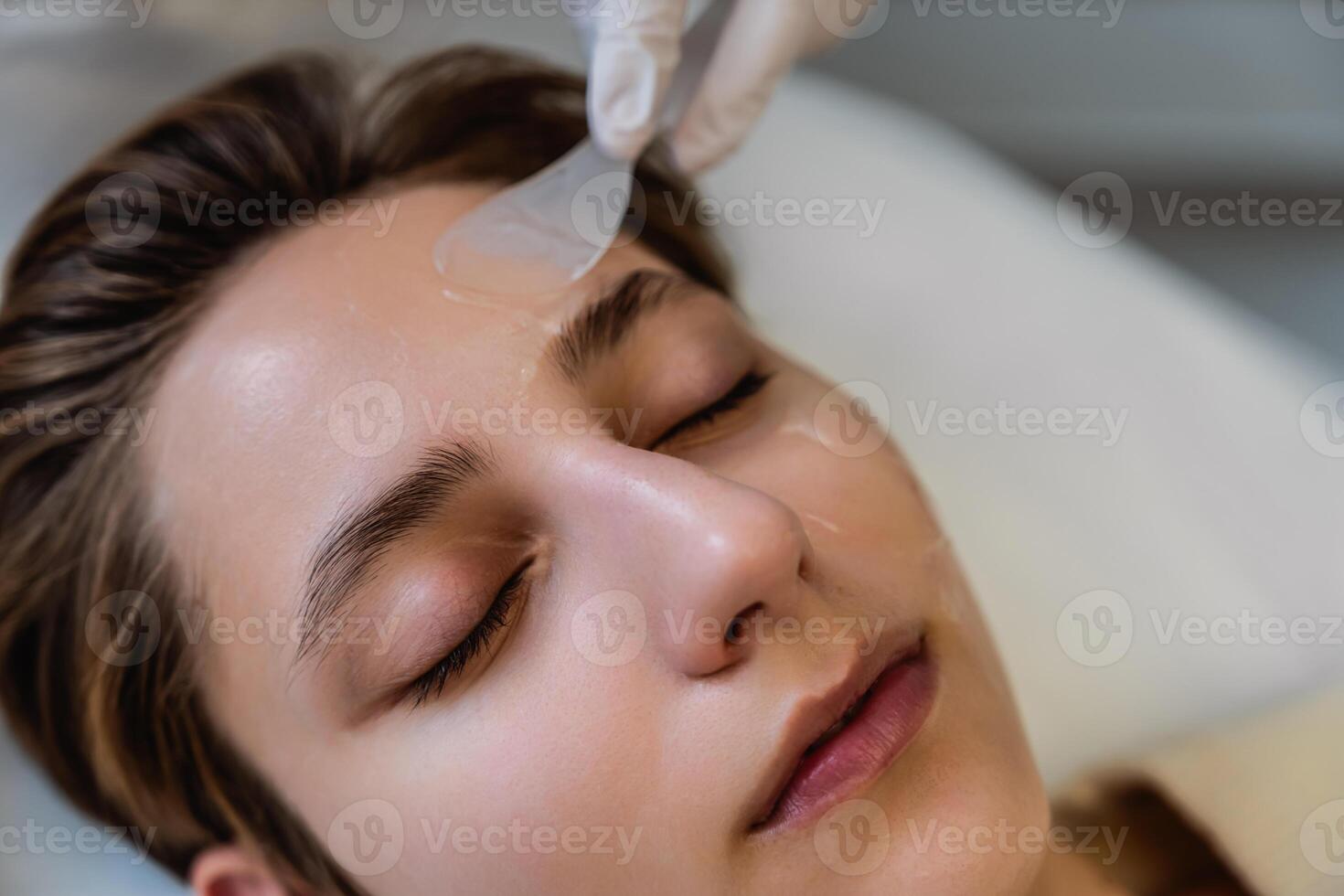 Woman receiving facial treatment at a skincare clinic in daylight photo