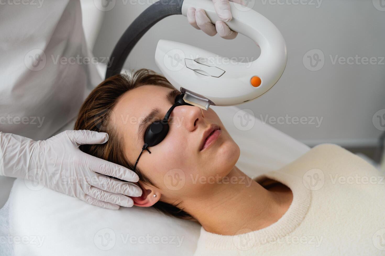 Woman receiving a facial treatment in a clinic during daylight hours photo