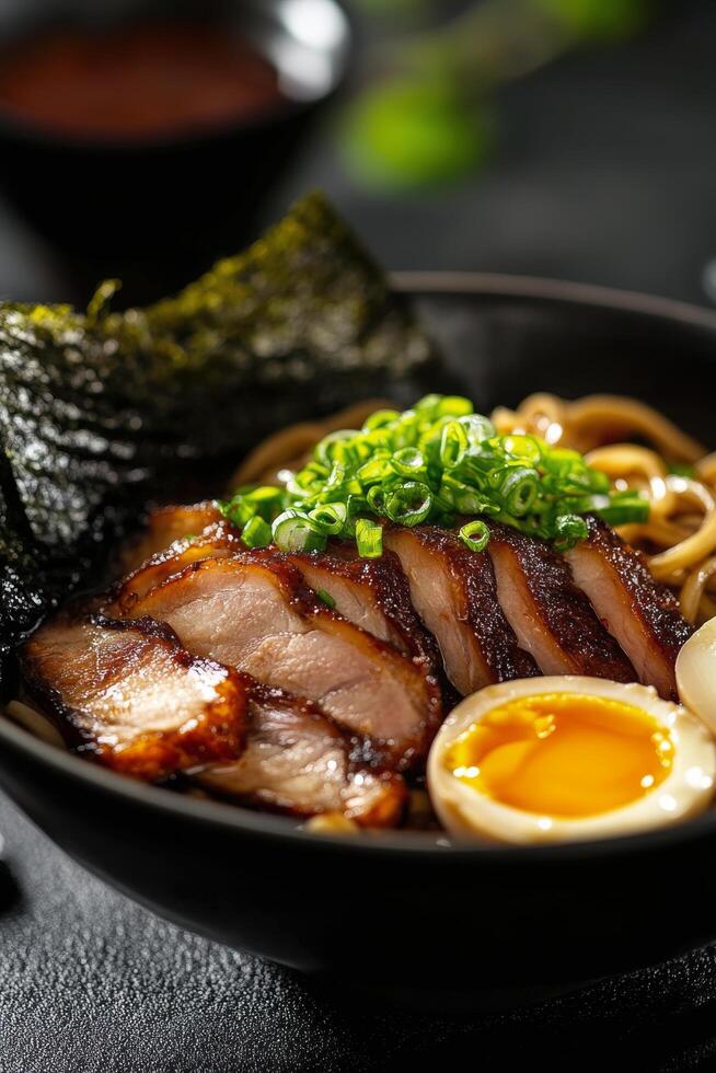 Delicious bowl of ramen topped with grilled chicken, green onions, and a soft-boiled egg photo