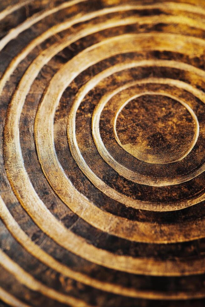 Intricate golden spiral patterns on a textured surface showcasing artistic craftsmanship photo