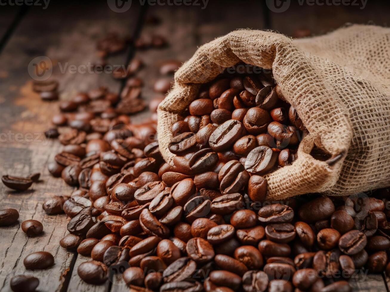 Dark brown coffee beans being poured out of a sack on a wooden background. This image conveys the freshness and aroma of the coffee beans. photo
