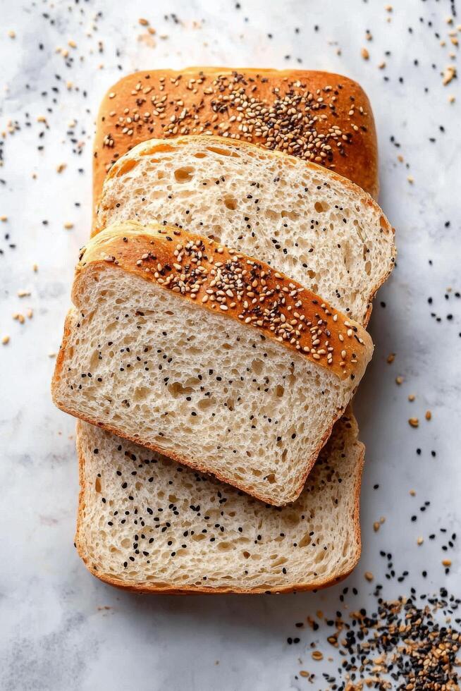 Slices of whole grain bread topped with seeds on a wooden cutting board photo