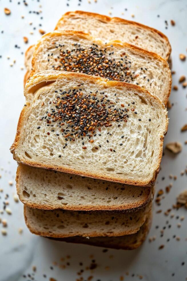 Slices of whole grain bread topped with seeds on a wooden cutting board photo