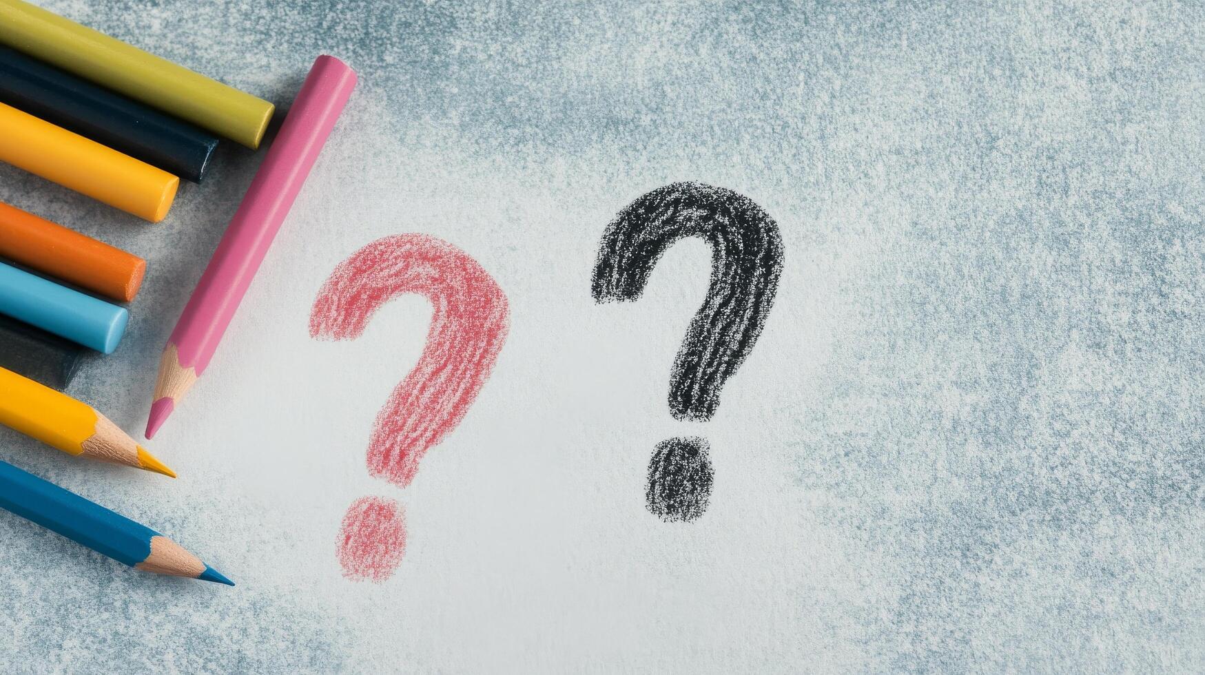 Three colored pencils beside a chalk question mark on a dark surface during daytime photo