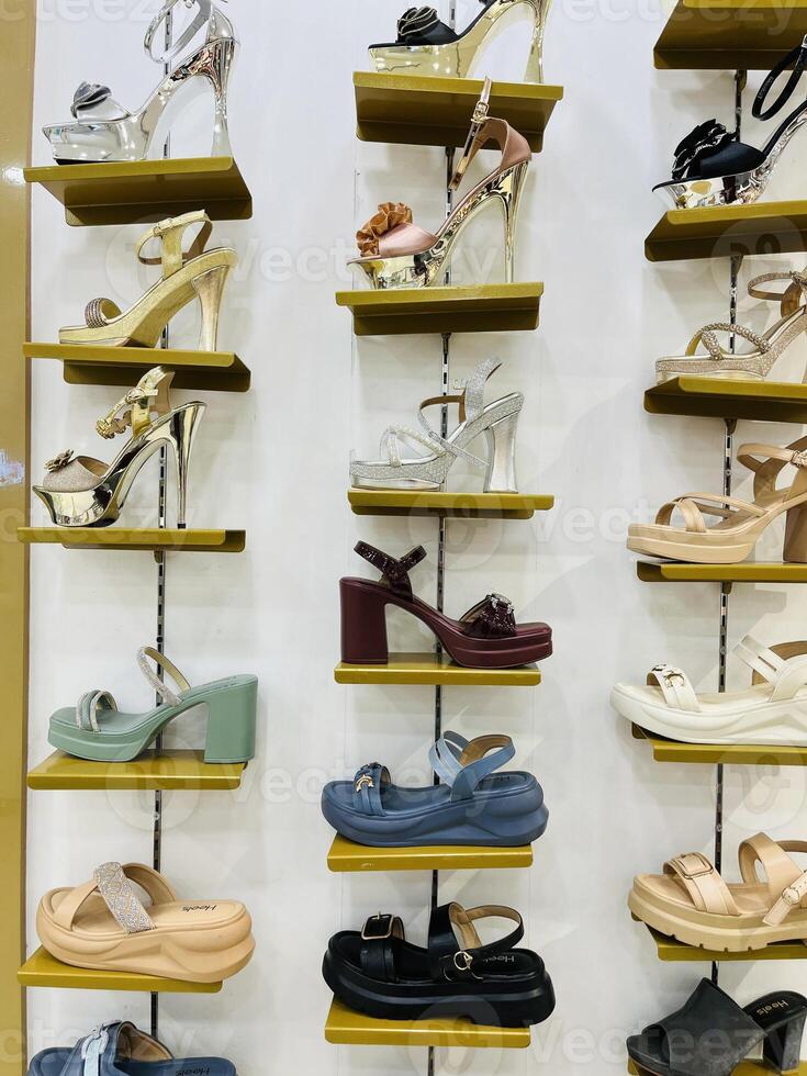 a display of shoes on shelves in a store in Lahore on July 28, 2024. photo