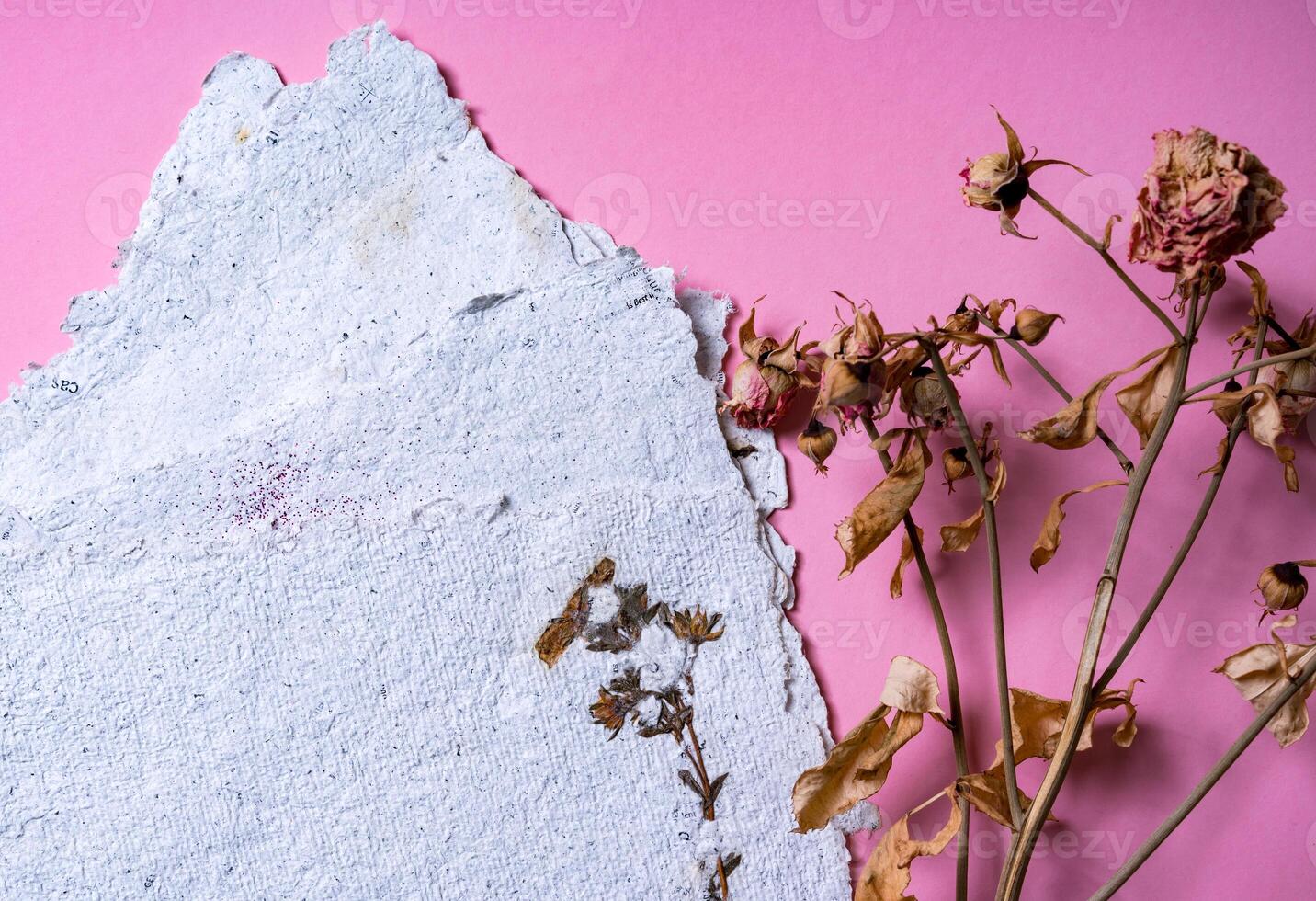Eco trends. Sheets of recycled paper with dried roses. Secondary production. Making paper with your own hands at home. photo