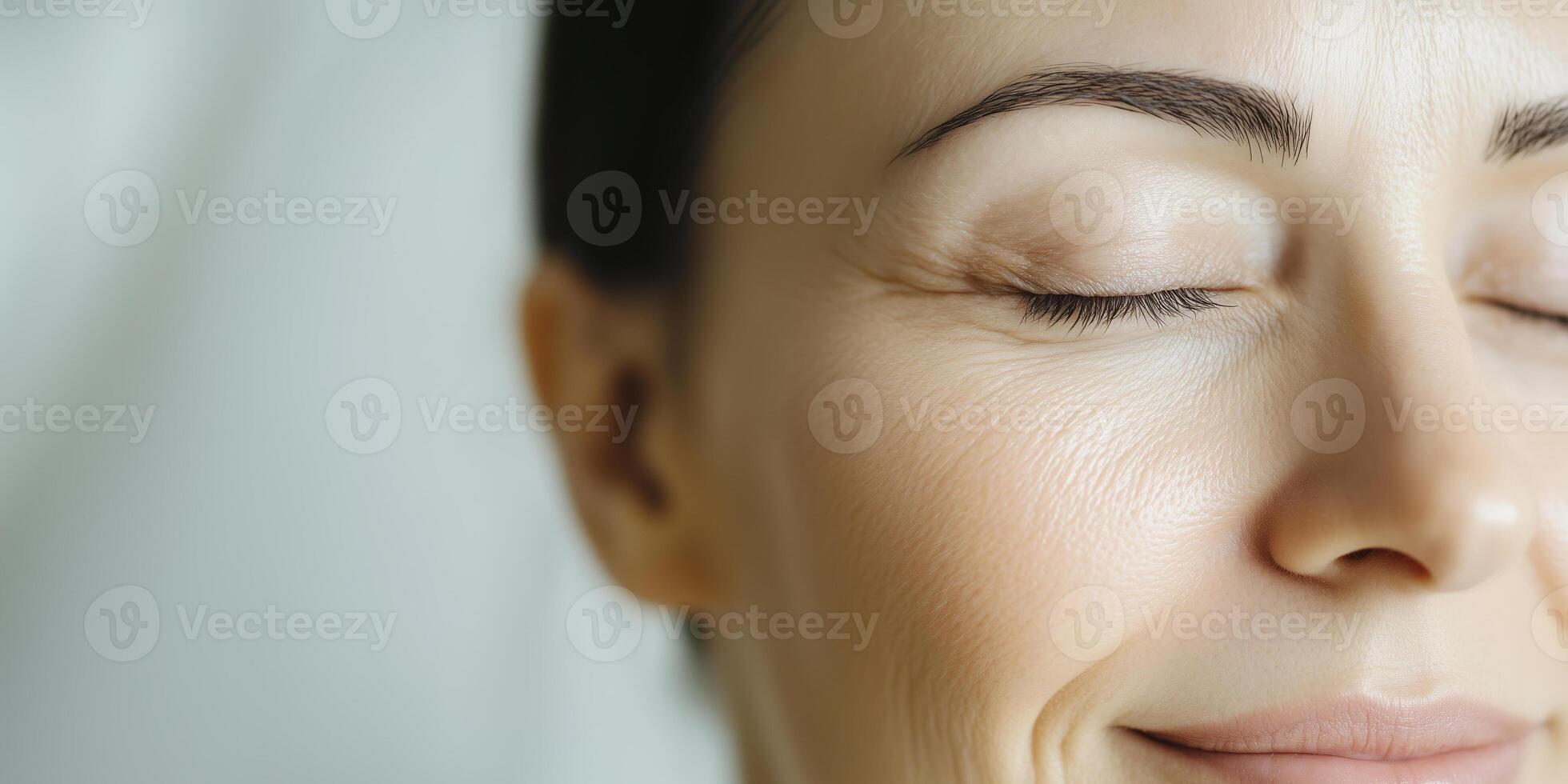Close-up of a relaxed woman's face with smooth skin and eyes closed. photo