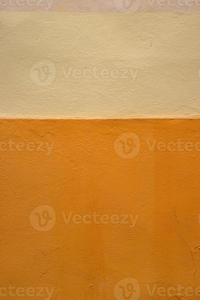 Vibrant orange wall texture with a subtle beige stripe, perfect for background, design inspiration or artistic project. Image of imperfections and unique details of an outdoor painted surface. photo