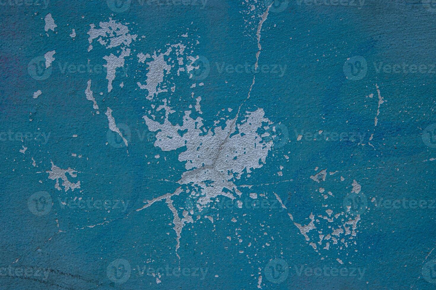Peeling paint and cracked blue wall texture background. Weathered decayed urban surface with chipped paint and cracks. Distressed, rustic aesthetic for graphic design, web design, digital art. photo