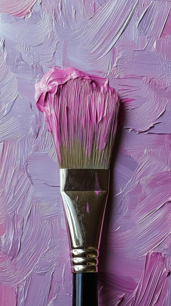 A close-up view of a paintbrush with vibrant purple paint on a textured pastel background photo