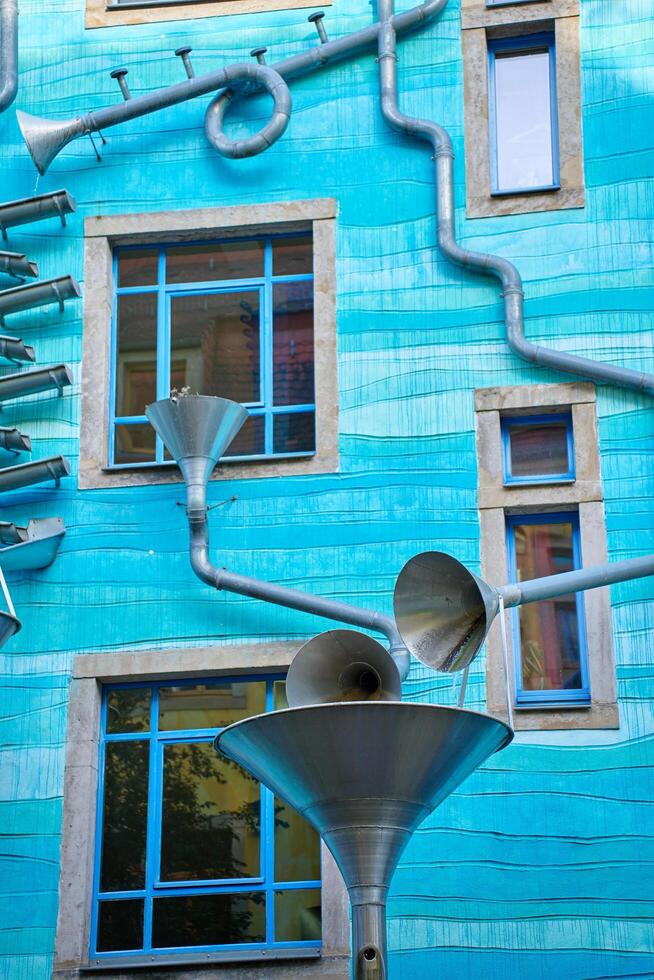 Kunsthofpassage in Neustadt district of Dresden, Germany. Quirky facade of residential building featuring musical instrument. Dresden, Germany - May 4, 2024 photo