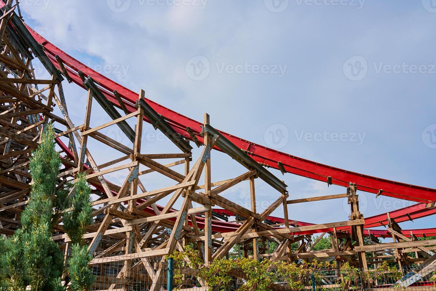 Roller coaster attraction in amusement park. Entertainment at summer holiday photo