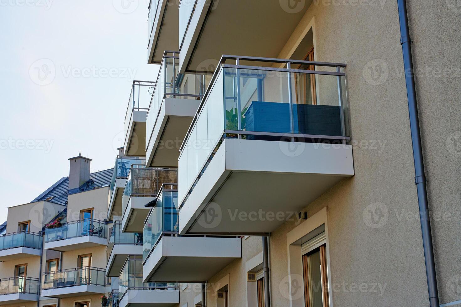 Multi story apartment building exterior. Residential building facade with balconies at summer day. Modern residential architecture in European city photo