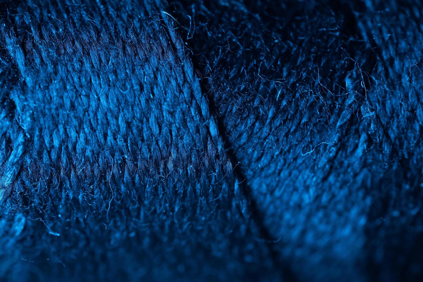 Fabric texture in macro, blue light, dark and light photo
