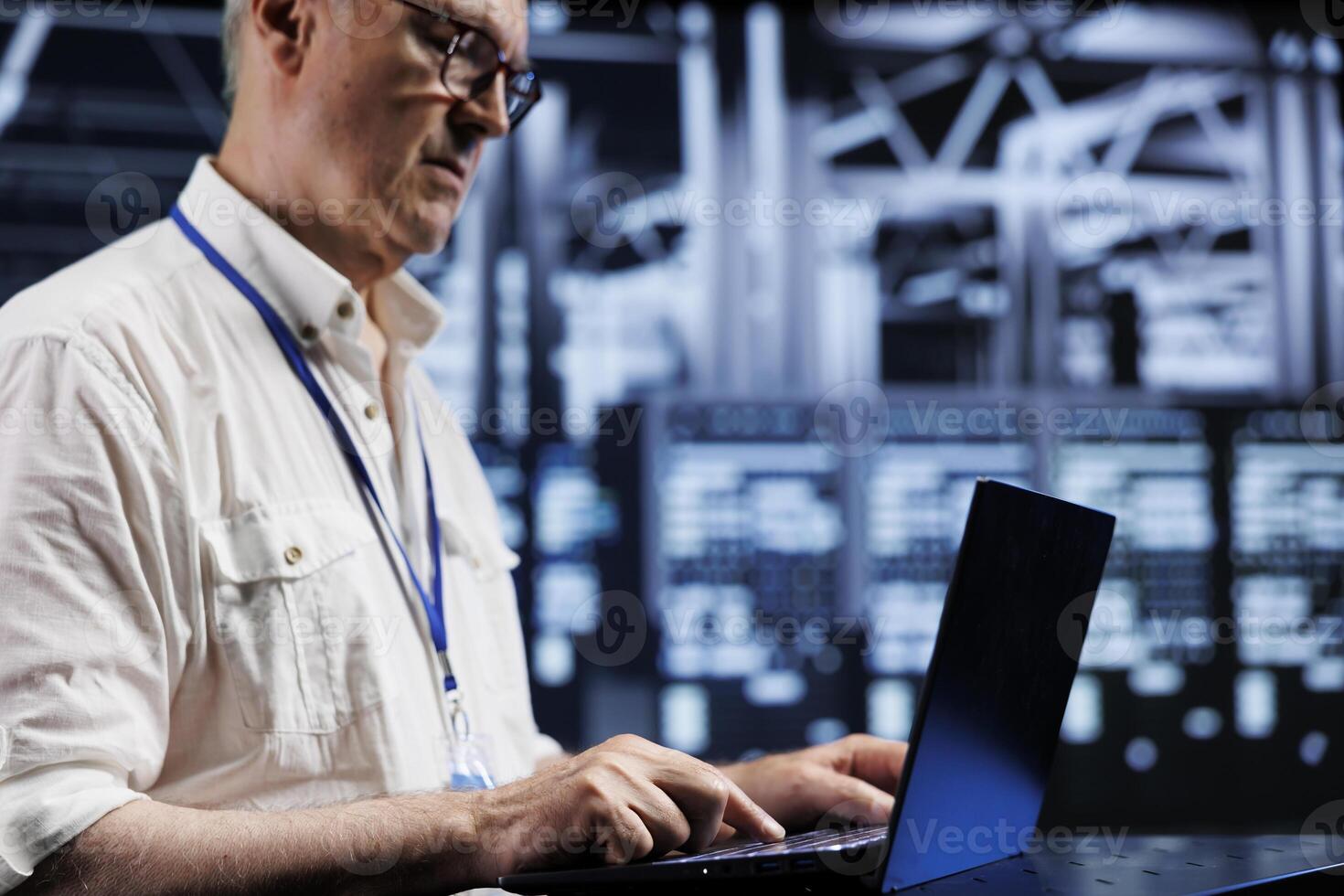 Octogenarian system administrator in data center providing dedicated VPN servers able to deliver enhanced privacy, encrypted sensitive data, online anonymity and stable internet connections to users photo