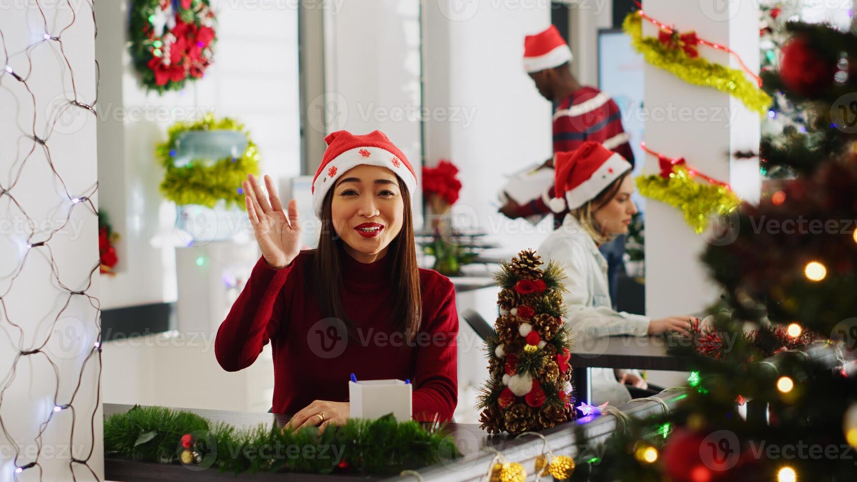 Portrait of asian manager in Christmas decorated workspace doing vlog for marketing social media channel, talking about company values, trying to attract new employees during winter holiday season photo