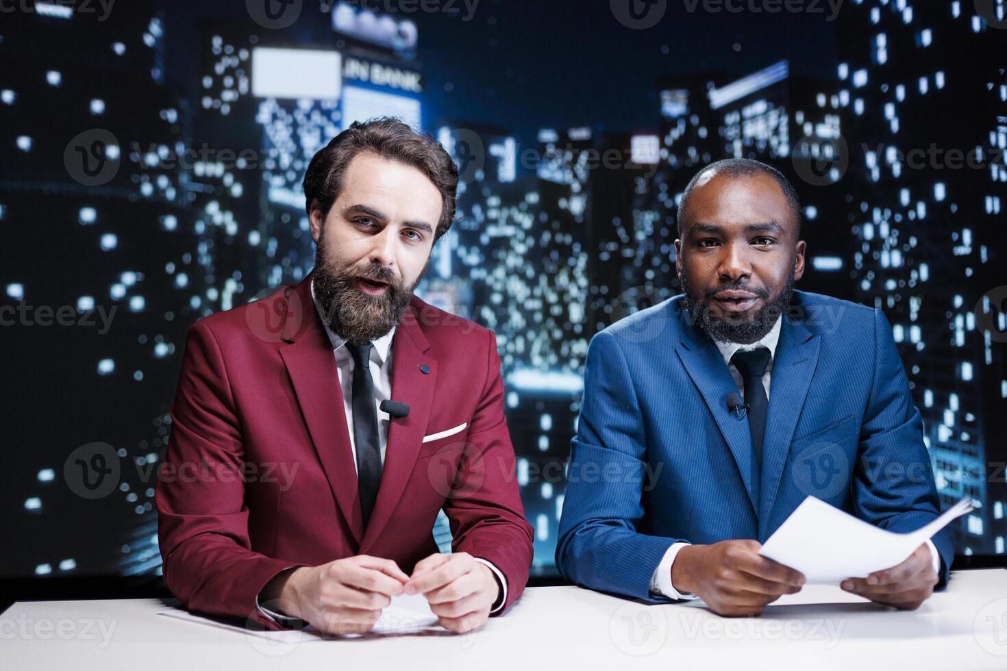 Diverse newscasters team reporting live news in media studio, presenting latest topics for global communications. Journalists working as night show hosts creating fun television content. photo