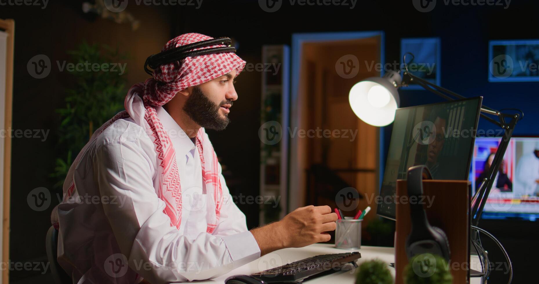 Muslim worker in call session with therapist, asking for advice, feeling down. Remotely working Middle Eastern employee in internet consultation with psychologist from stylish cozy home photo