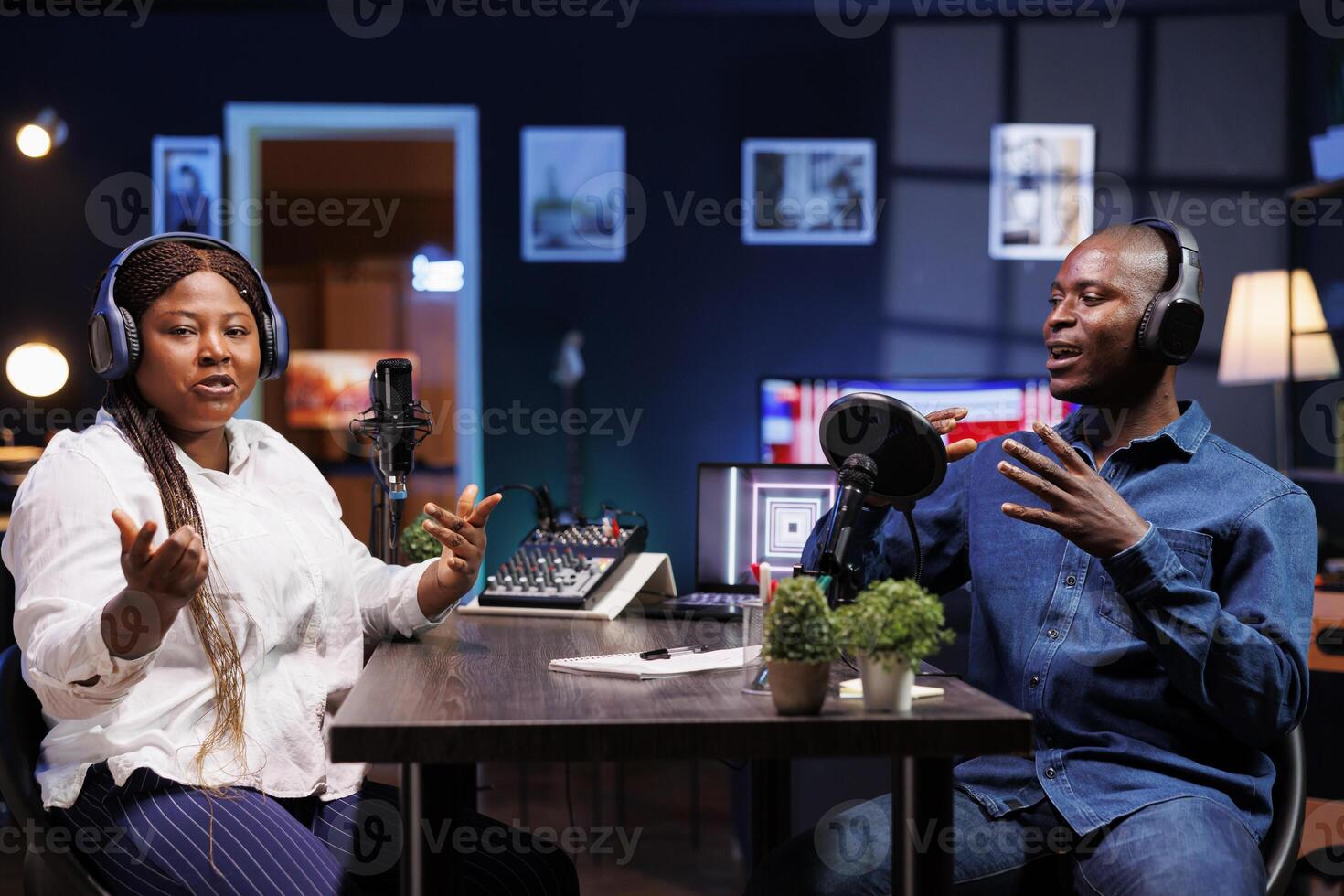 Man and woman produce content for online channel in a talk show setting. Male host interviews a female influencer with a professional microphone, creating engaging content for their digital audience. photo