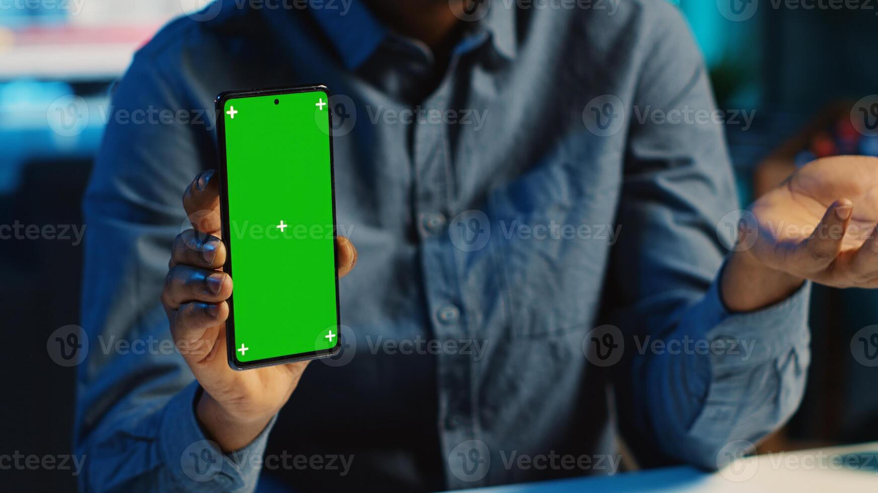 Content creator films chroma key smartphone review for tech enthusiasts, close up. Viral online star hosts technology internet show, unboxing isolated screen cellphone, focus on product photo