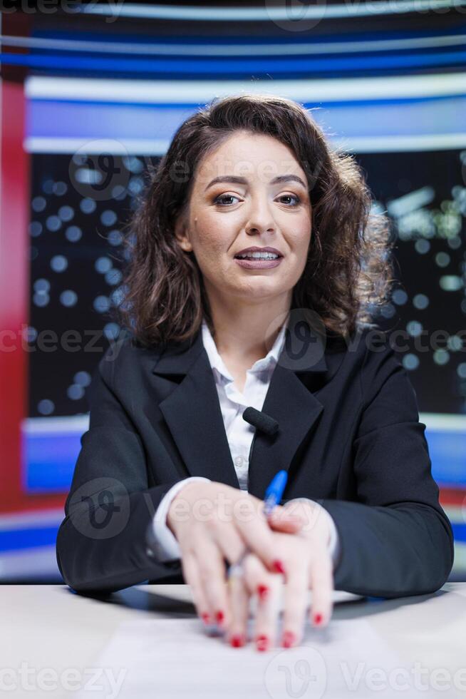 Woman broadcaster transmitting live breaking news in media studio, discussing about latest happenings and interesting events. Journalist reading headlines and giving insight to viewers. photo
