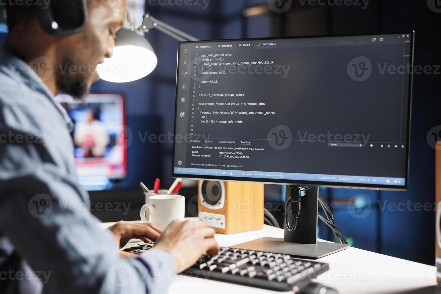 On terminal window, african american internet programmer writes server code in binary and machine language. Fixing security issues of databases as a young network engineer, remote work. photo
