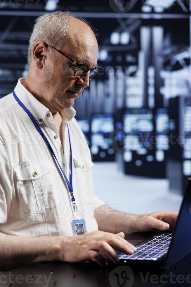 Senior experienced technician in data center providing dedicated VPN servers able to deliver enhanced privacy, encrypted sensitive data, online anonymity and secure internet connections to users photo