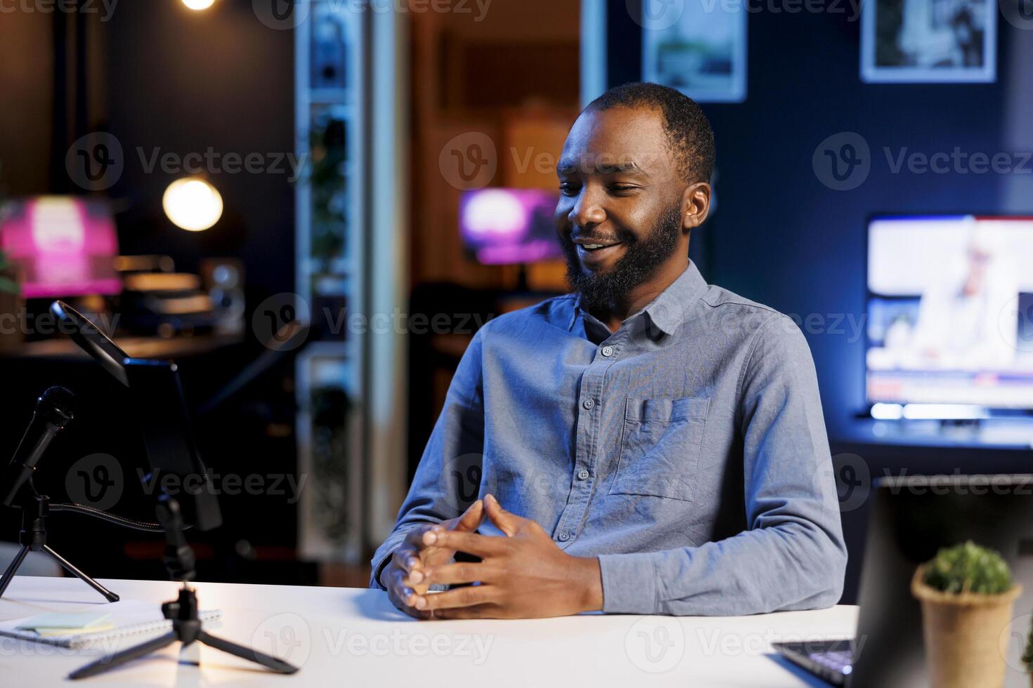 Cheerful online star filming technology review of various electronics, unboxing them and presenting features to audience. Internet show host showing product recommendations to social media followers photo