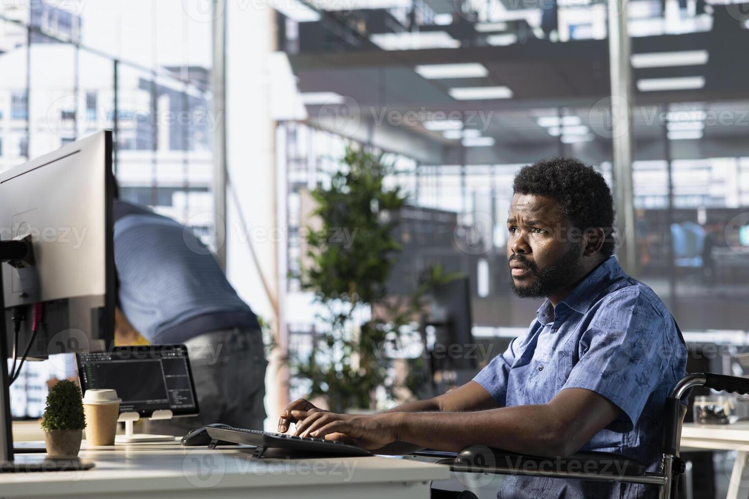 Person with paraplegia conducting code review to fix bugs, identifying potential performance and technical issues with company software. IT worker with disability in wheelchair optimizing code photo