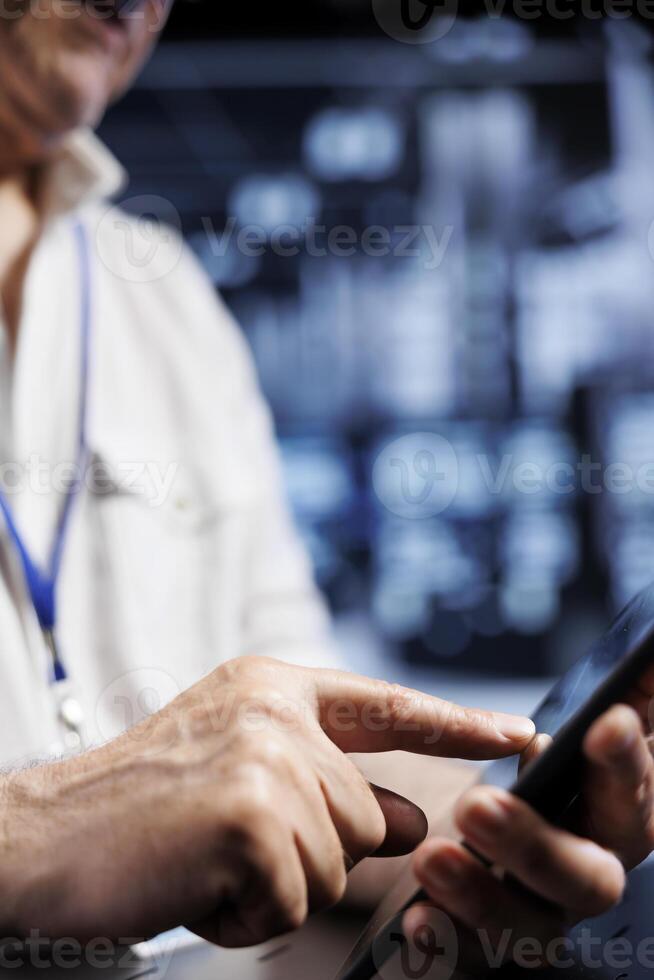 Computer scientist using tablet in high tech workspace, installing dedicated VPN servers able to provide encrypted sensitive data, online anonymity and fast speed bandwidth to clients, close up photo