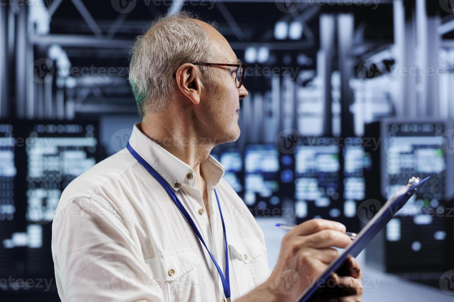 Elderly engineer in crypto mining farm with specialized hardware using Blockchain technology. Fintech expert holding clipboard, inspecting asic rigs solving complex computational problems photo