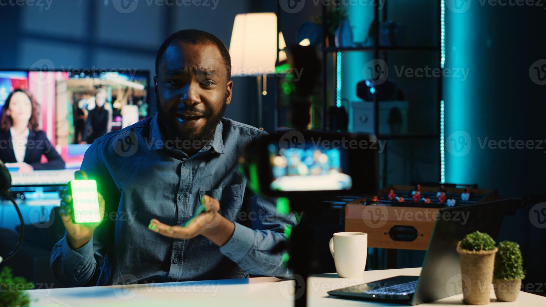 BIPOC tech content creator filming technology review of mini RGB lights device, unboxing and presenting informations to audience. Internet star showing production equipment to subscribers photo