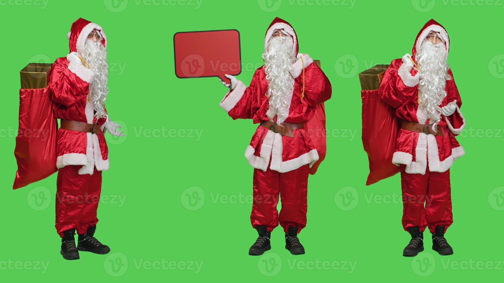 Saint nick with bag and speech bubble posing over greenscreen to advertise new christmas eve holiday marketing. Santa in suit showing empty red cardboard icon for advertisement. photo