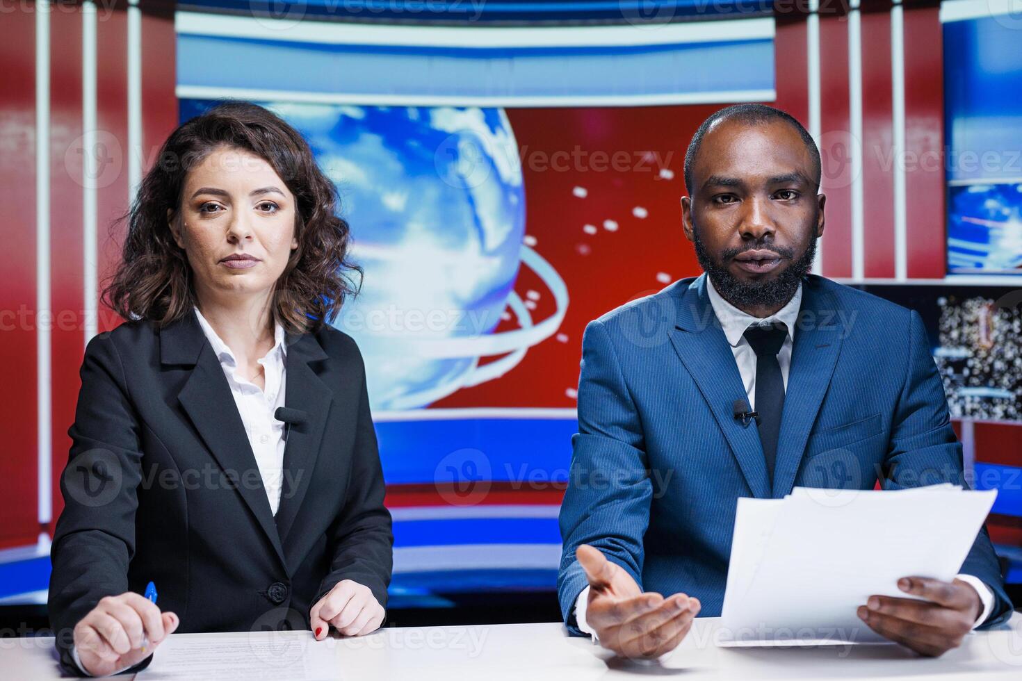 Diverse reporters doing newscast live on television broadcast, hosting morning show in newsroom. Two journalists talking about media topics with latest information from headlines. photo