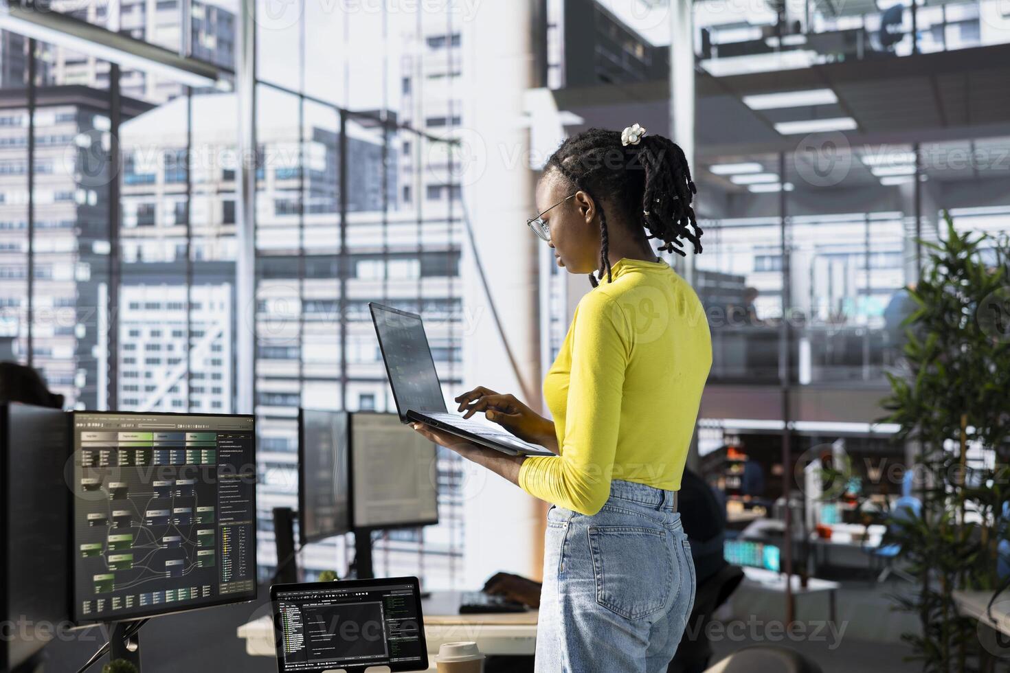 Machine learning infrastructure technician using laptop to develop algorithms that enable machines to learn from data. Admin in office training large scale deep learning models using notebook photo
