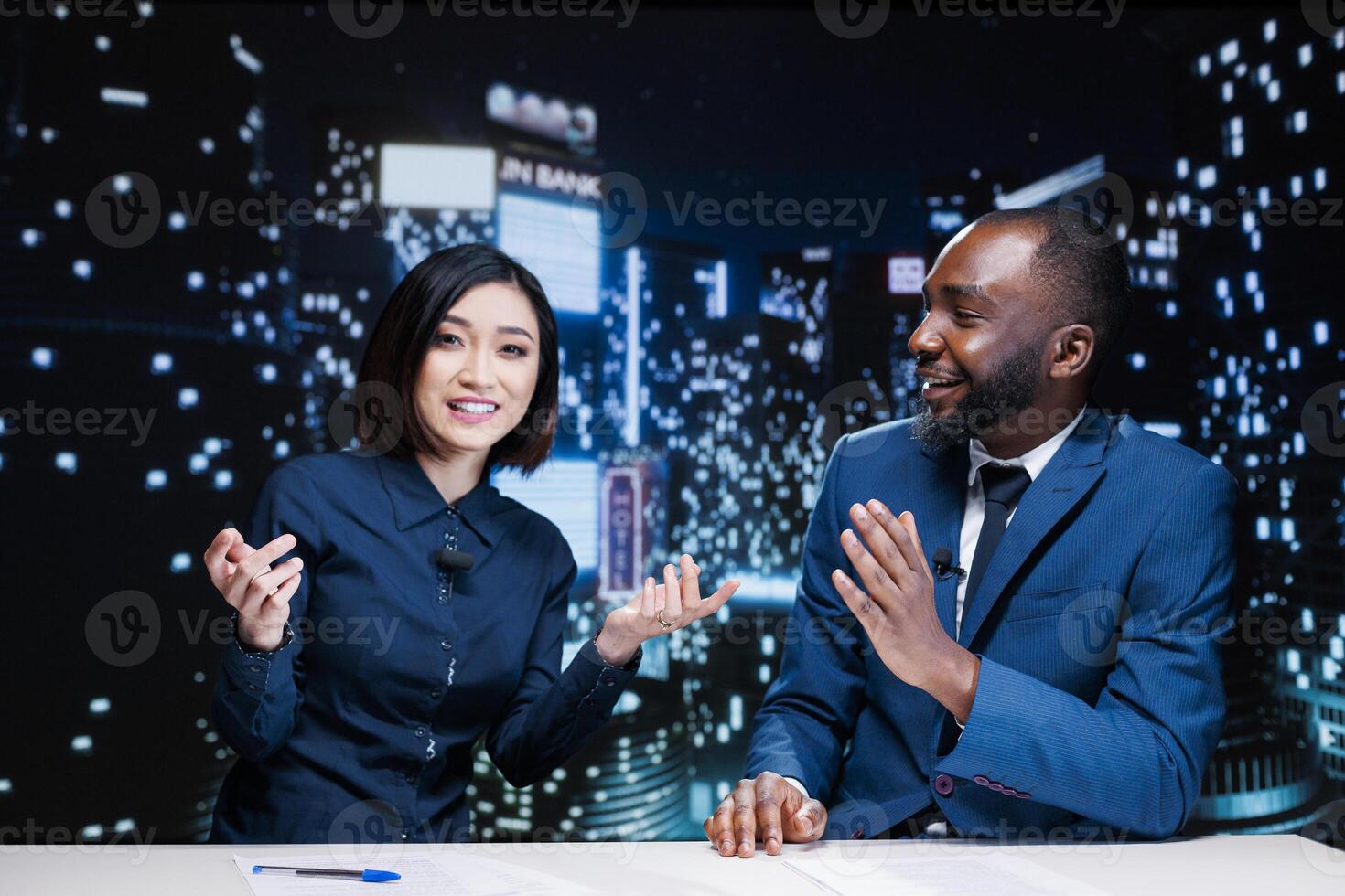 Journalists team on late night show discussing about latest information from media newspapers, global communications. Diverse presenters working on television content, broadcasting live. photo