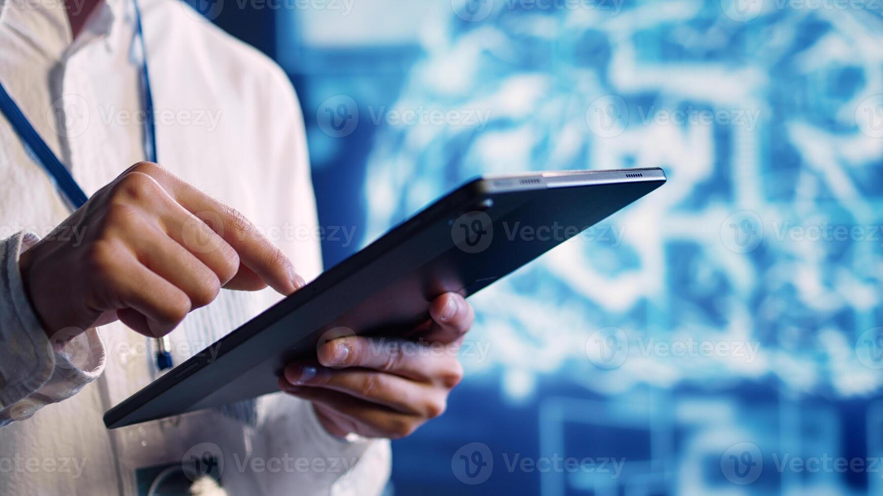 Close up shot of adept scientist in data center uses artificial intelligence computing simulating human brain thought processes. Skillful specialist works on tablet with AI machine learning algorithms photo