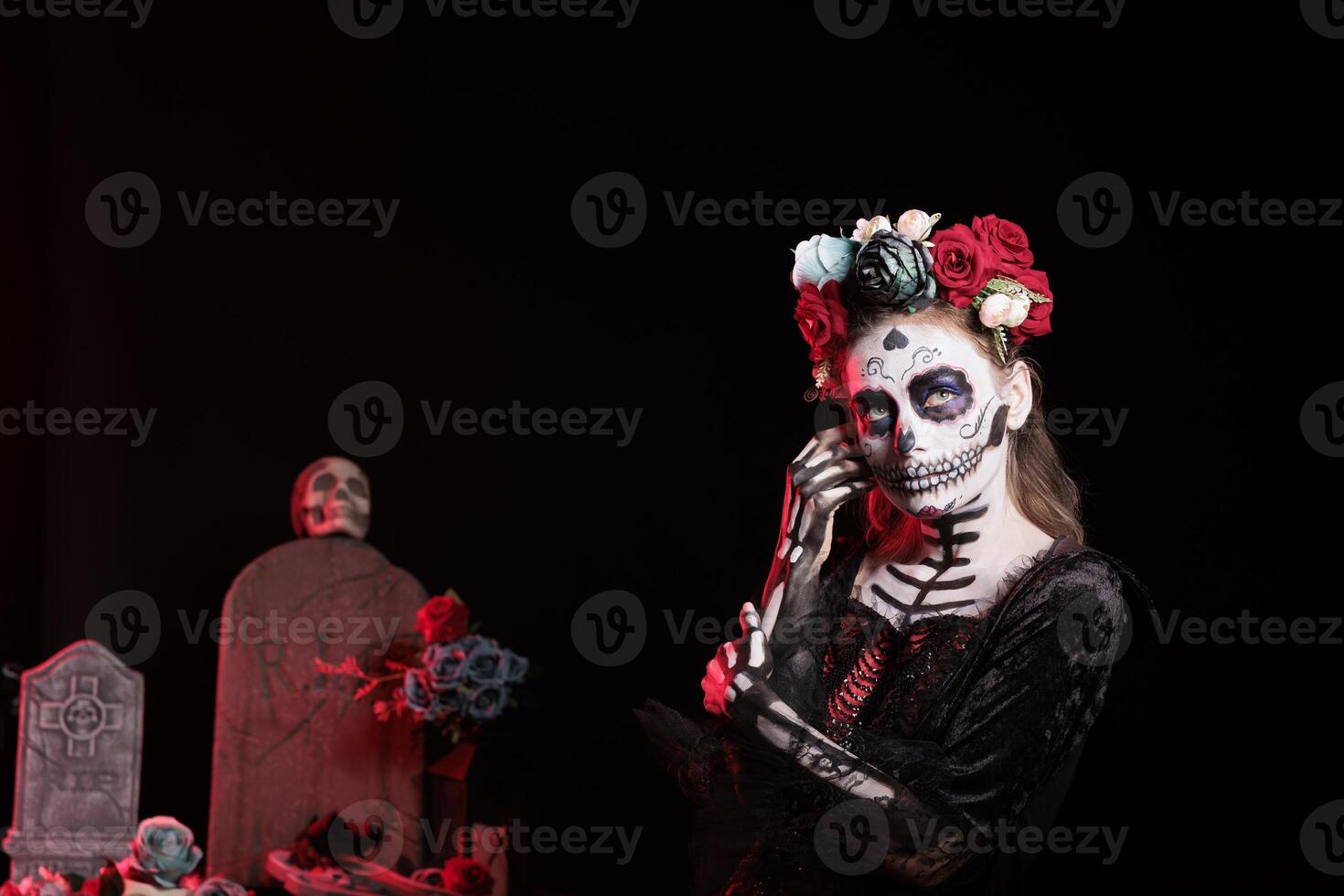 Woman building altar during Day of the Dead event to remember the deceased and celebrating their memory. Lady dressed for mexican holiday of remembrance and celebration for those who have passed photo