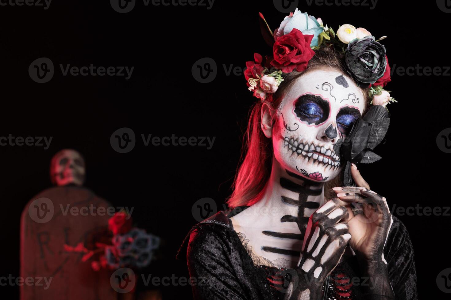 Woman holding black rose, doing indigenous rituals of honoring the dead during Dia de los Muerte. Person hugging flower, participating in Day of the Dead, Mexico annual fiesta in honor of the deceased photo